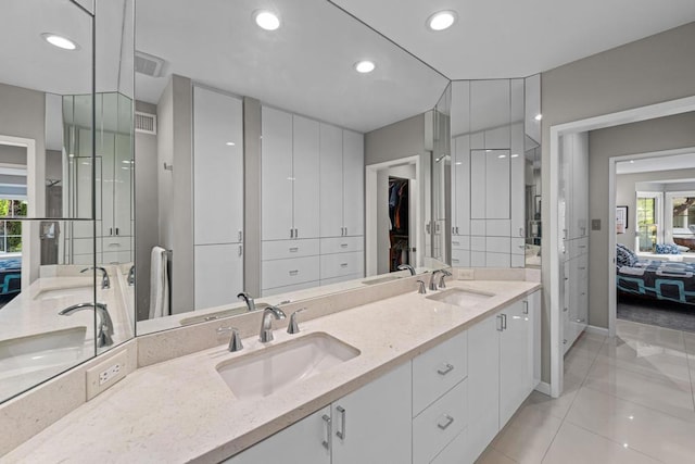 bathroom with tile patterned flooring and vanity