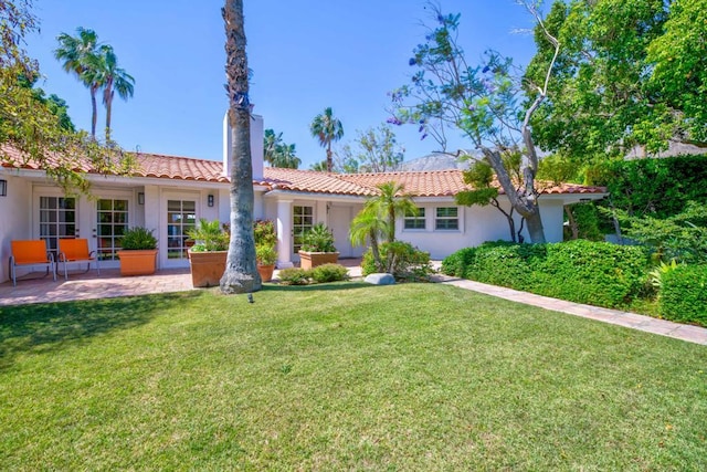 mediterranean / spanish home featuring a front lawn