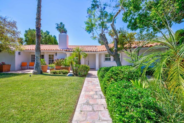 mediterranean / spanish-style house with a front yard