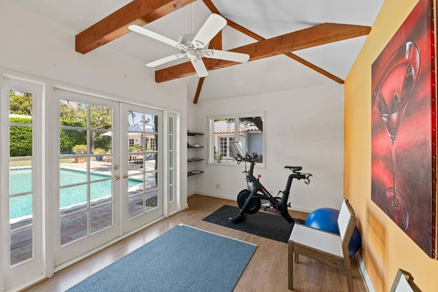 workout room with ceiling fan, light hardwood / wood-style floors, lofted ceiling, and french doors