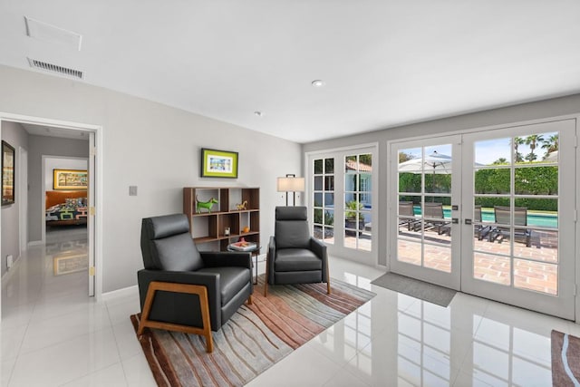 sitting room with light tile patterned floors and french doors