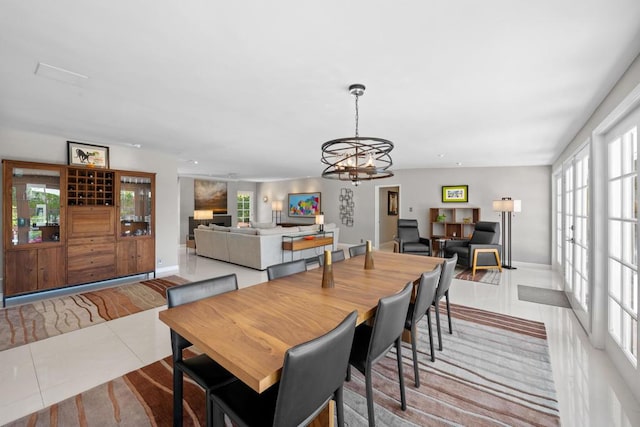 tiled dining room featuring a chandelier