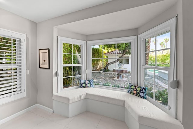 doorway to outside with light tile patterned floors