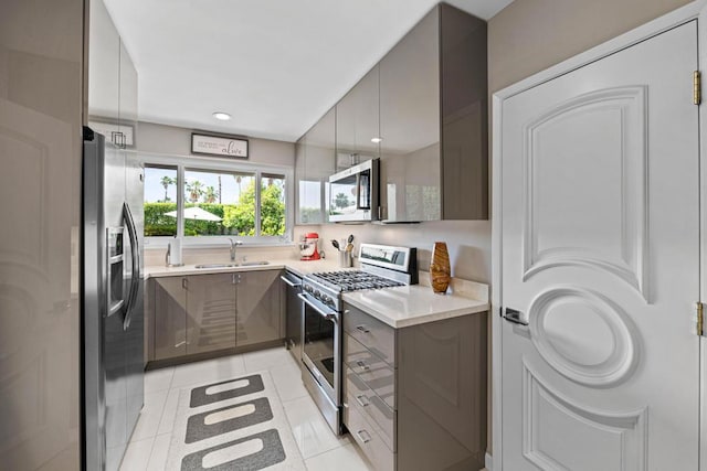 kitchen with sink, appliances with stainless steel finishes, and light tile patterned flooring