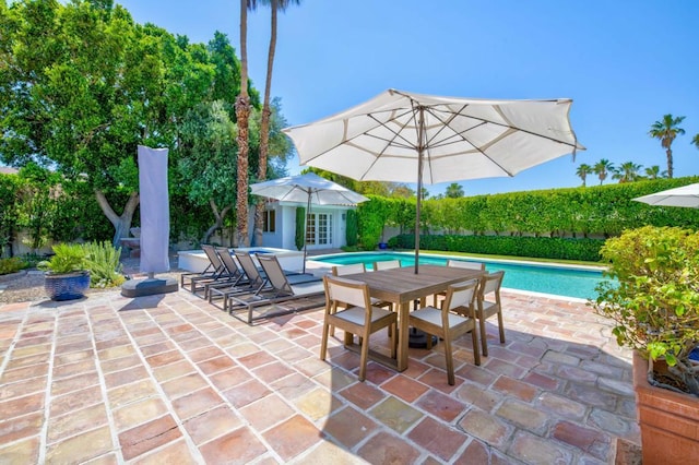 view of patio / terrace featuring an outbuilding and a fenced in pool