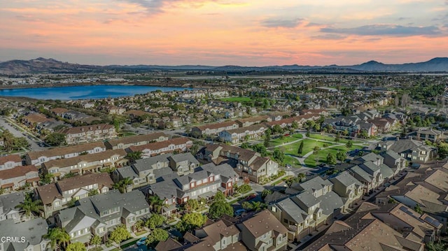 aerial view at dusk with a water and mountain view