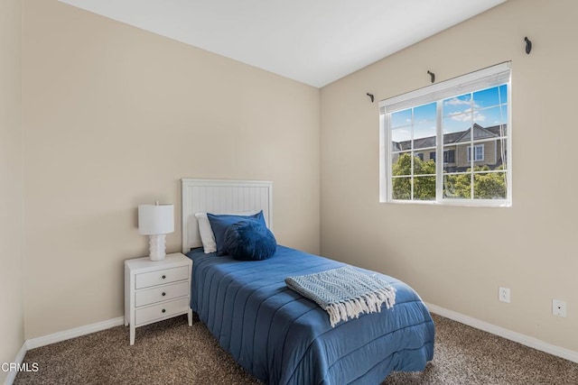 bedroom featuring dark colored carpet