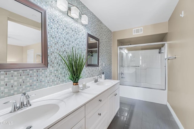 bathroom featuring vanity, decorative backsplash, and enclosed tub / shower combo