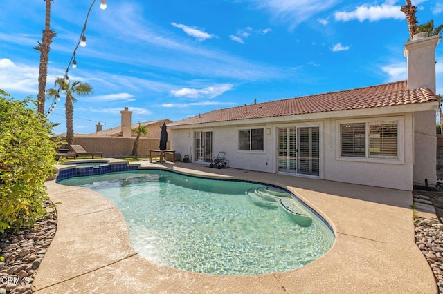 view of swimming pool with an in ground hot tub and a patio