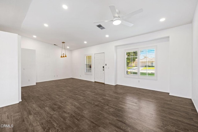 spare room featuring ceiling fan and dark hardwood / wood-style floors