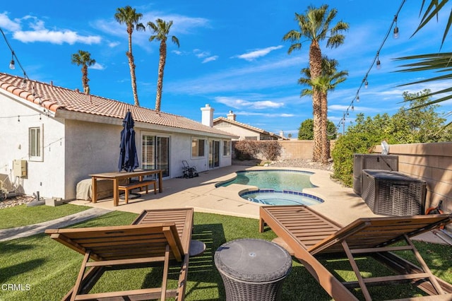 view of swimming pool featuring an in ground hot tub, a patio area, and a lawn