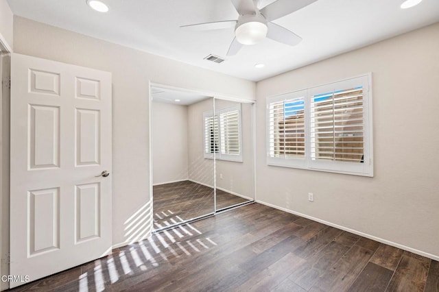 unfurnished bedroom featuring ceiling fan, a closet, and dark hardwood / wood-style floors