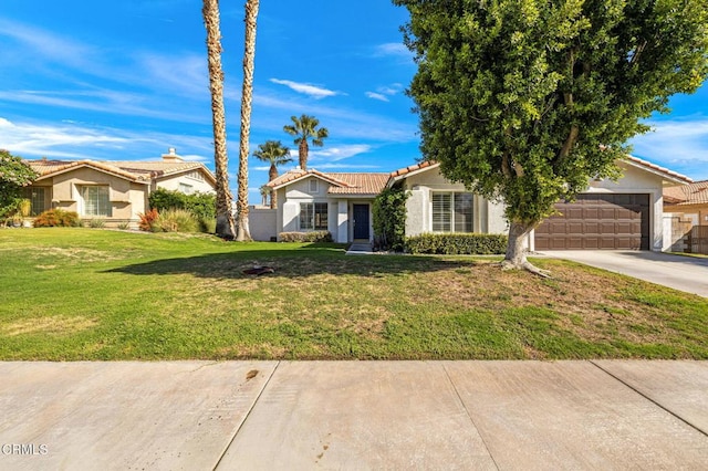 view of front of home with a front yard and a garage