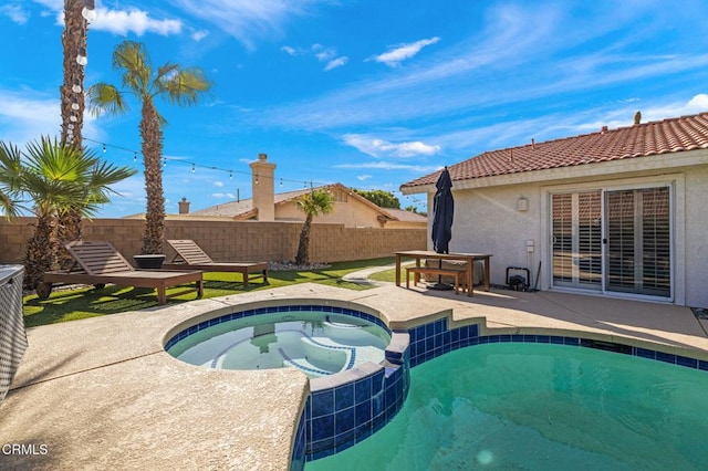 view of swimming pool featuring an in ground hot tub and a patio