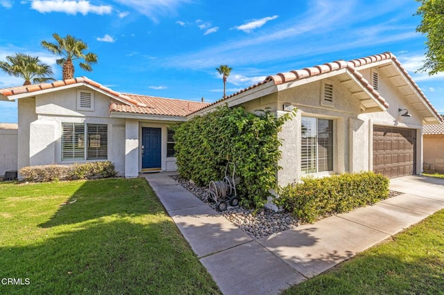 view of front of property with a garage and a front yard