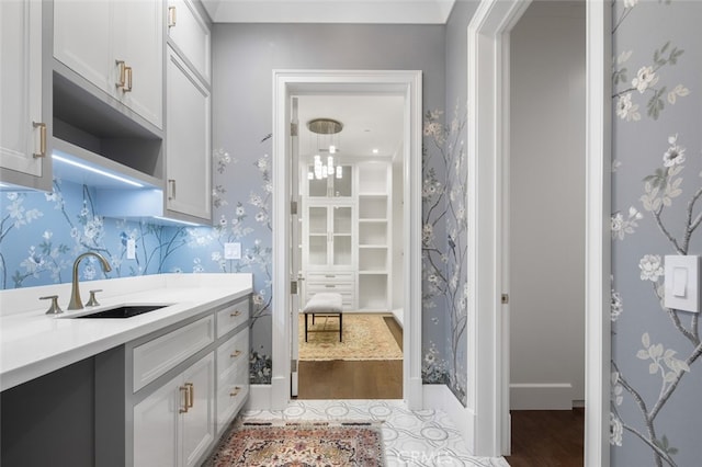 kitchen featuring white cabinets and sink