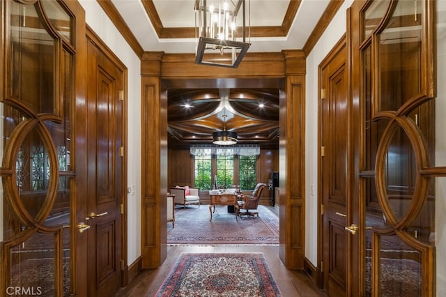 hallway featuring crown molding and a notable chandelier