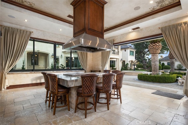 interior space featuring a high ceiling, extractor fan, and crown molding