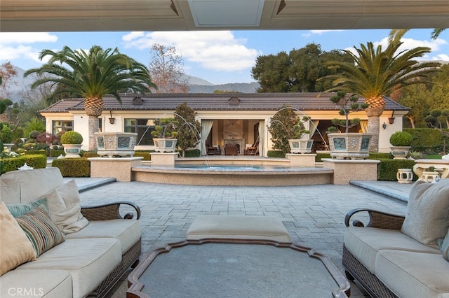 view of patio with an outdoor living space and a mountain view