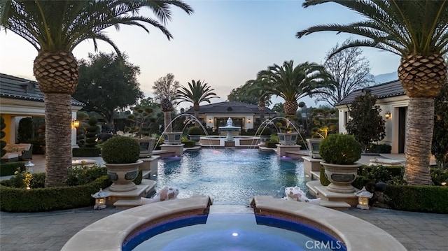 view of pool at dusk