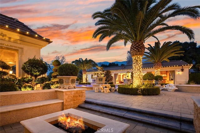 patio terrace at dusk with a fire pit