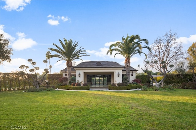 rear view of property featuring a lawn