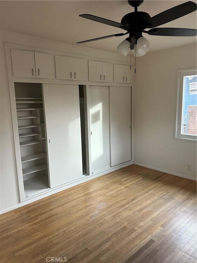 unfurnished bedroom featuring light wood-type flooring, ceiling fan, and a closet