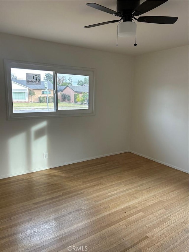 empty room featuring ceiling fan and light wood-type flooring