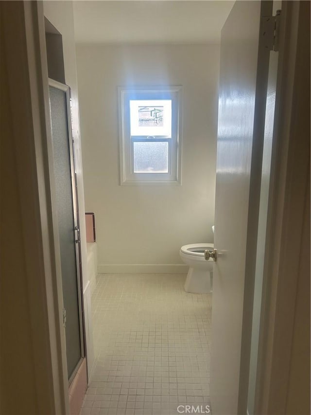 bathroom featuring toilet and plus walk in shower