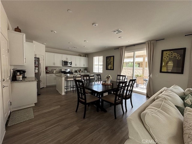 dining area with dark hardwood / wood-style flooring