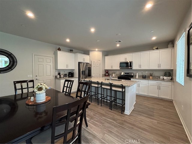 dining room featuring hardwood / wood-style flooring and sink