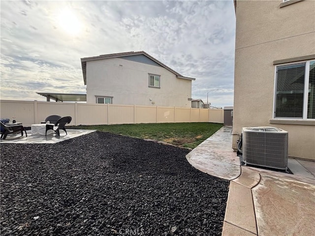 view of yard featuring central air condition unit and a patio area