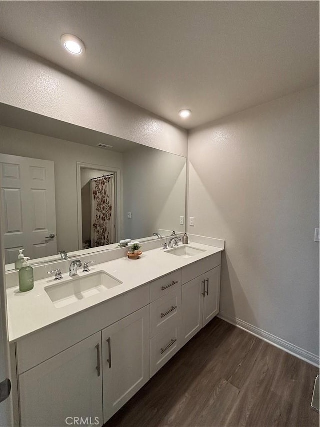 bathroom featuring hardwood / wood-style flooring and vanity