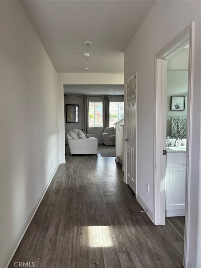 hallway with dark wood-type flooring