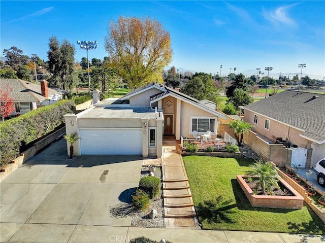 view of front of house with a garage and a front lawn