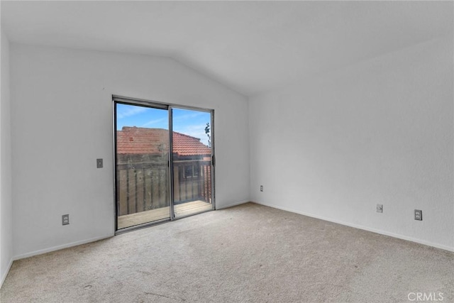 unfurnished room featuring vaulted ceiling and light colored carpet