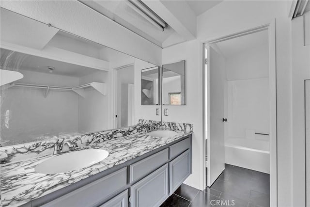 bathroom featuring shower / bath combination, tile patterned floors, and vanity