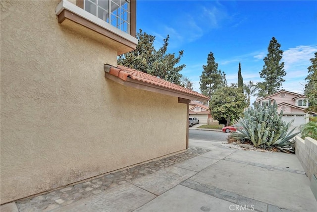 view of side of home with a patio