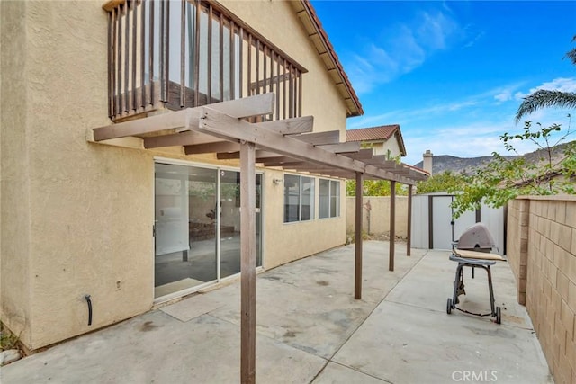 view of patio featuring a shed and a pergola