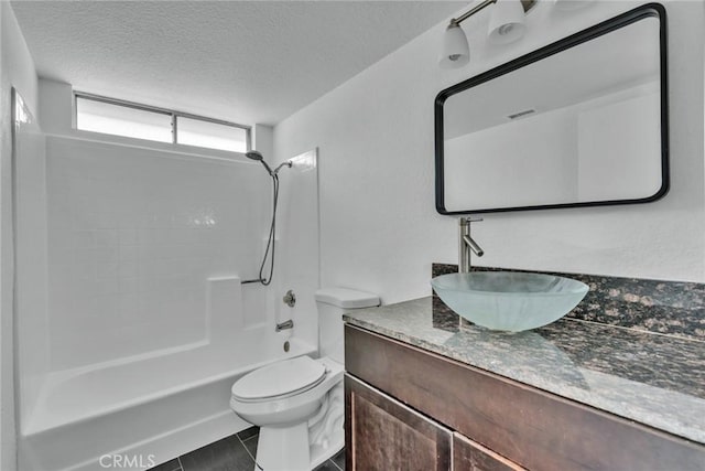 full bathroom featuring toilet, washtub / shower combination, tile patterned flooring, a textured ceiling, and vanity