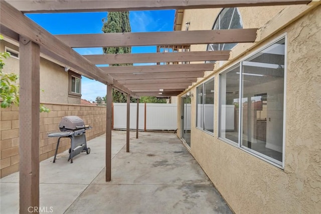 view of patio featuring grilling area and a pergola