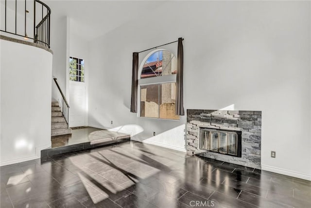 living room with dark tile patterned flooring and a fireplace