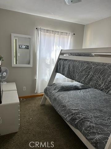 bedroom featuring dark colored carpet