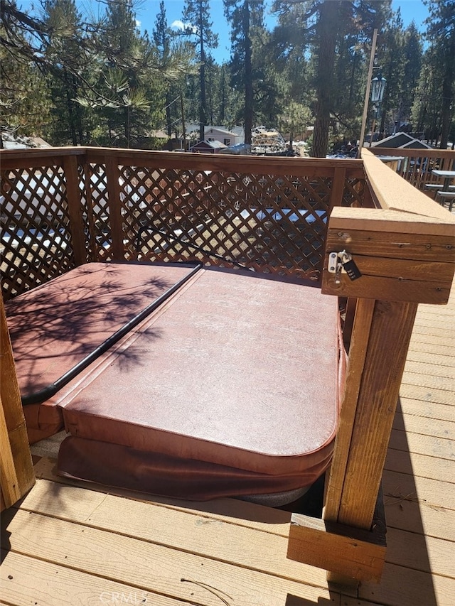 wooden deck featuring a jacuzzi