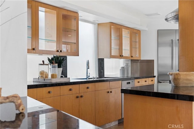 kitchen with built in refrigerator, sink, and dishwashing machine