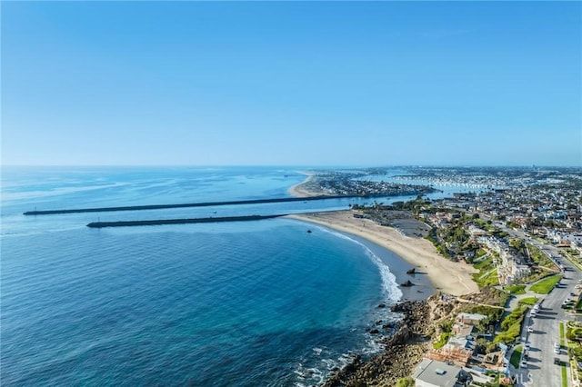 drone / aerial view with a water view and a beach view