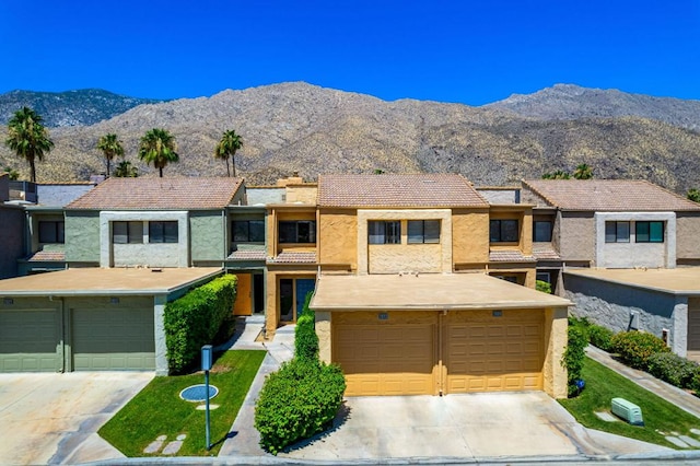 multi unit property featuring a garage and a mountain view