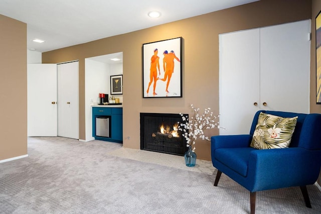 sitting room featuring light carpet