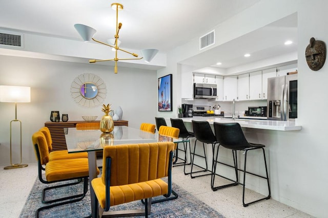 dining area featuring a notable chandelier