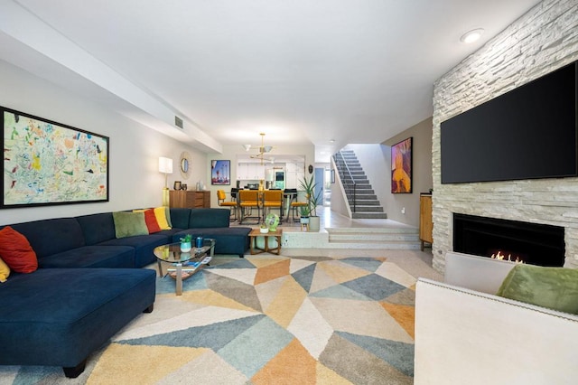 living room featuring light carpet and a fireplace